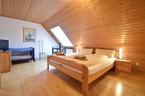 a bedroom with a large bed in a wooden wall at Haus Krabbe in Norddeich