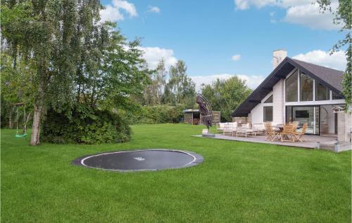 a home with a trampoline in the yard at 2 Bedroom Amazing Home In Gilleleje in Gilleleje