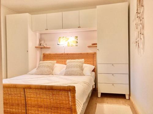 a small bedroom with a bed with white cabinets at Ferienwohnung Crawissimo in Crawinkel