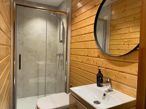 a bathroom with a shower and a sink and a mirror at Olden Glamping - One with nature in Stryn