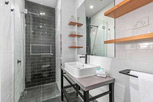 a white bathroom with a sink and a shower at New York on Moorabool - Free Wi-Fi in Geelong