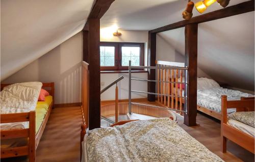 Cette chambre mansardée comprend 2 lits superposés et un escalier. dans l'établissement Nice Home In Bytw With Wifi, à Bytów