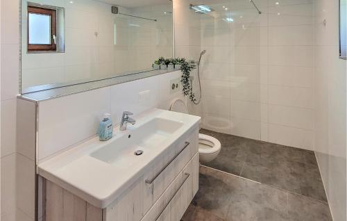 a white bathroom with a sink and a toilet at Amazing Home In Prerow With Wifi in Prerow