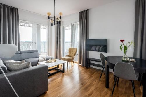 a living room with a couch and a table at Apartamenty City Tower od WroclawApartament-pl in Wrocław
