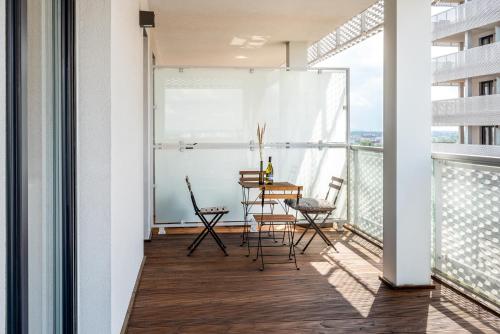 a balcony with a table and chairs on a building at Apartamenty City Tower od WroclawApartament-pl in Wrocław