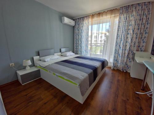 a bedroom with a large bed and a large window at Diamond Beach Sarafovo by KP in Burgas City