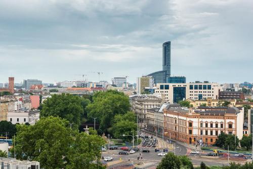 a view of a city with buildings and cars at Apartamenty City Tower od WroclawApartament-pl in Wrocław