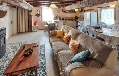 a living room with a couch and a table at Gîte Aux Hirondelles in Pouilly-sous-Charlieu
