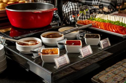 a buffet with various food items on a table at Hotel Kindermann in Caçador