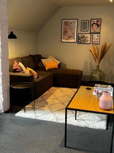a living room with a couch and a table at Pivoné Assebroek in Bruges