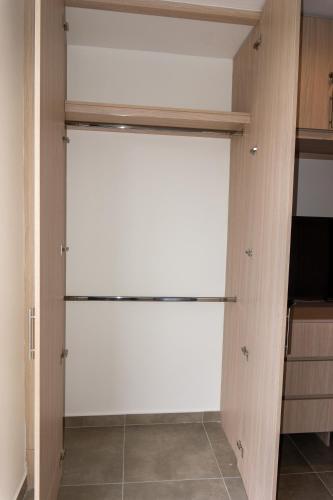a closet with a white door in a room at confortable apartasuite en la playa in Gaira