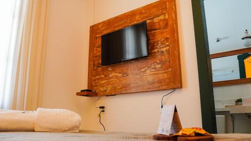 a room with a tv on a wall with at Pouso da Rita - Tiradentes in Tiradentes