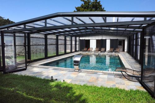 a swimming pool under a metal canopy at Alminhas da Mindua in Vitorino dos Piães