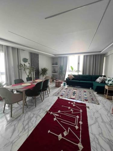 a living room with a couch and a table with chairs at Newly refurbished flat,Marble floors.Central Cairo in Cairo