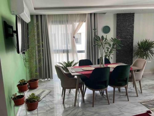 a dining room with a table and chairs at Newly refurbished flat,Marble floors.Central Cairo in Cairo