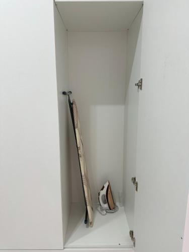 a baseball bat and helmet in a white cabinet at Apart Inn - Апарт Отель in Uralsk