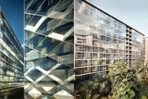 a tall glass building with trees in front of it at Newly refurbished flat,Marble floors.Central Cairo in Cairo