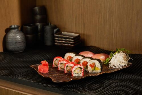 a plate of sushi on top of a table at Marine Hotel by Zdrojowa in Kołobrzeg