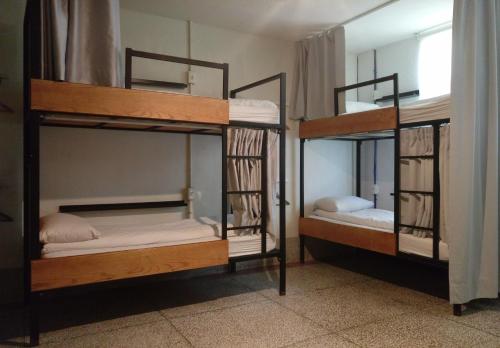 two bunk beds in a room with a window at Happy Taipei Hostel - Share House - Monthly in Taipei