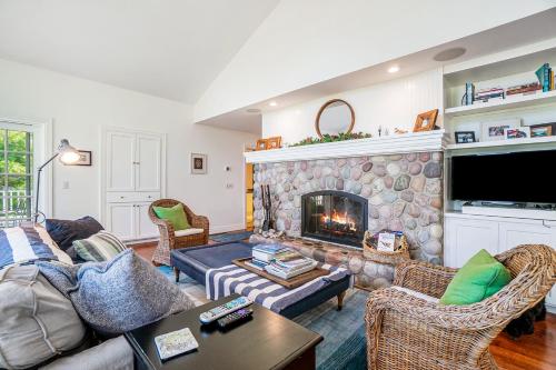 a living room with a couch and a fireplace at Blue Bear in Glen Arbor