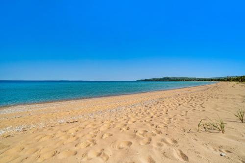 a sandy beach with the ocean in the background at Blue Bear in Glen Arbor