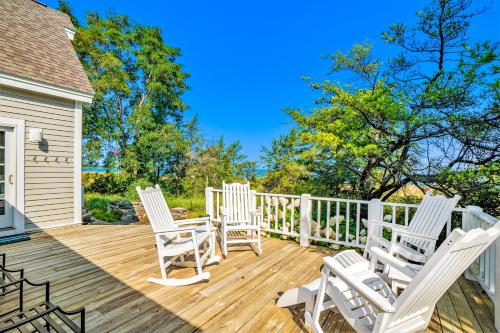 three rocking chairs sitting on a wooden deck at Blue Bear in Glen Arbor