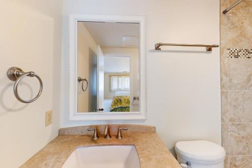a bathroom with a sink and a mirror at Turnberry Village 291 in Hilton Head Island