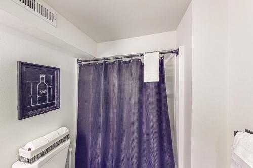 a bathroom with a purple shower curtain at Woodin-villa in Woodinville