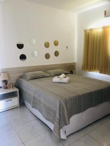 a bedroom with a bed with two towels on it at Casa Paradise Fiore in Paripueira