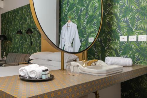 a bathroom with a sink and a mirror at Faranda Collection Barranquilla, a member of Radisson Individuals in Barranquilla