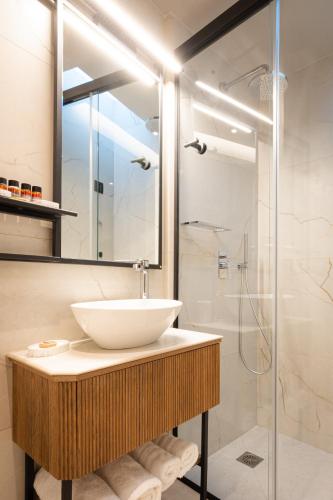 a bathroom with a sink and a shower at Navria by Aetoma in Nafplio
