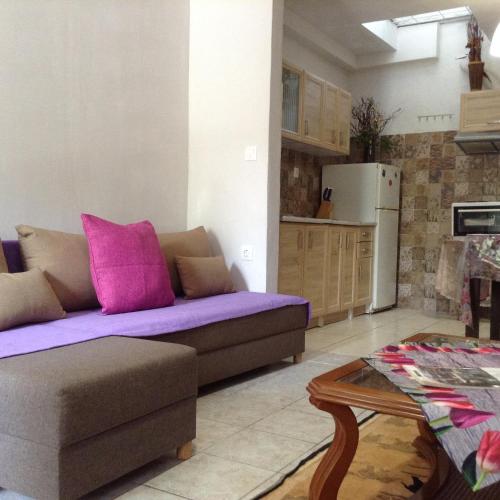 a living room with a couch and a table at Η in Volos