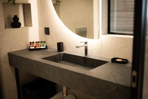 a bathroom with a sink and a mirror at Navria by Aetoma in Nafplio