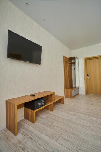 a living room with a flat screen tv on a wall at Готель У Борисовича & SPA in Palyanytsya