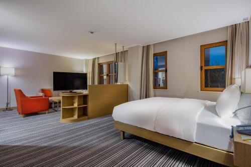 a hotel room with a bed and a living room at Hilton Garden Inn Safranbolu in Safranbolu