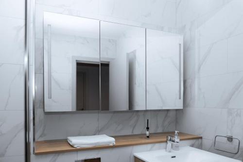 a bathroom with a sink and a large mirror at Luxurious stunning 2bedroom apartment in Manchester