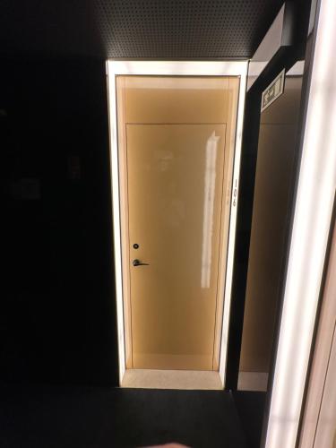 a white door in a room with a black wall at Golden Lisbon Hotel in Lisbon