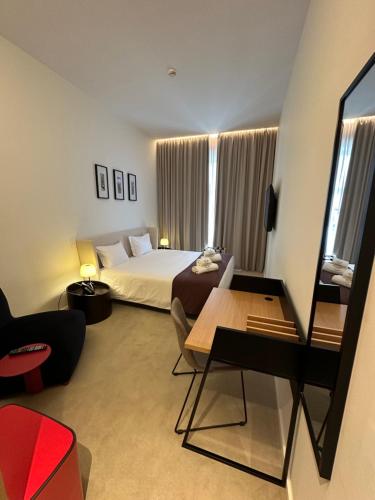 a hotel room with a bed and a table at Golden Lisbon Hotel in Lisbon