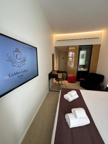 a room with two white towels on a table at Golden Lisbon Hotel in Lisbon