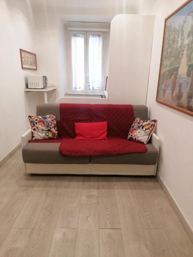 a living room with a red couch in a room at Da Adriana al vaticano in Rome