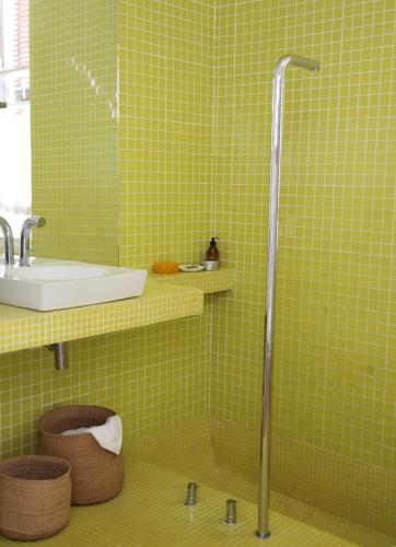 a green tiled bathroom with a shower and a sink at InAweStays Holiday Homes in Cape Town