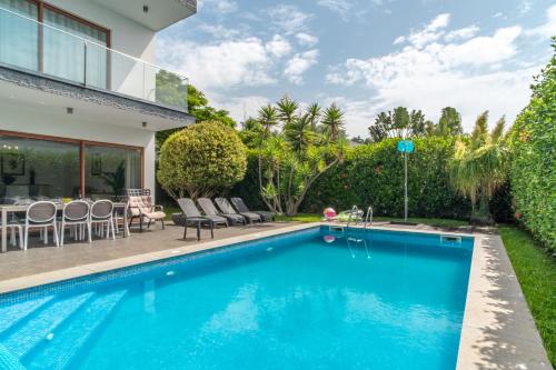a swimming pool in the backyard of a house at Star Villa with private heated pool in funchal in Funchal