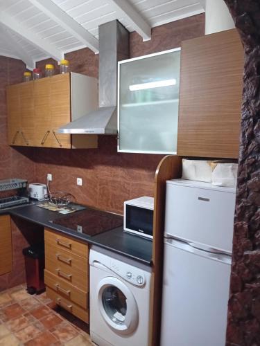 a kitchen with a washing machine and a washer at T 1 +1 Ref 004 in Tavira