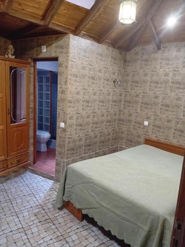 a bedroom with a bed and a bathroom with a toilet at T 1 +1 Ref 004 in Tavira