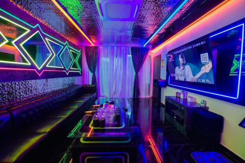 a room with a bar with neon lights at Dato Villa Luxury Homestay 12min to Jonker Street 26pax Private Pool Playground KTV BBQ in Melaka