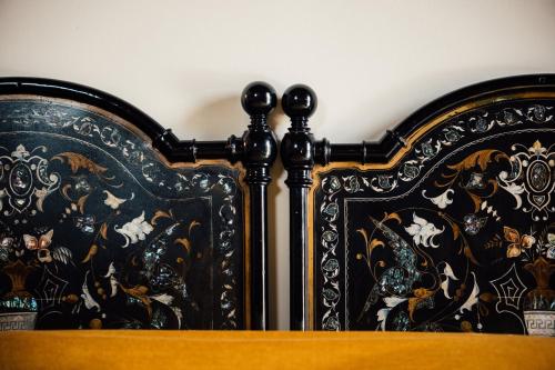 a bed with black and gold designs on it at Albergo La Meridiana in Castelnuovo del Garda