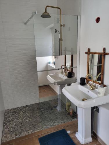 a bathroom with two sinks and a shower at Le Clos in Corcelles-les-Monts