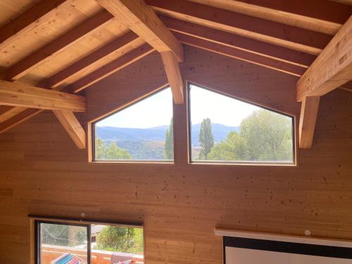 a room with three windows in a wooden house at Chalet deS'AMY et sa terrasse pour 8/10 personnes in Font Romeu Odeillo Via