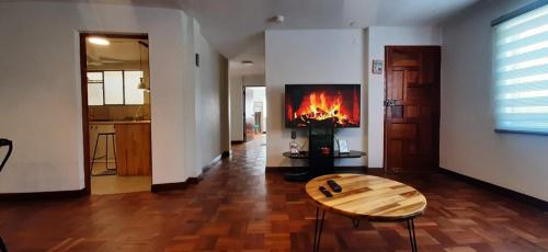 sala de estar con chimenea y mesa en Acogedor apartamento cerca del teleférico amarillo en La Paz