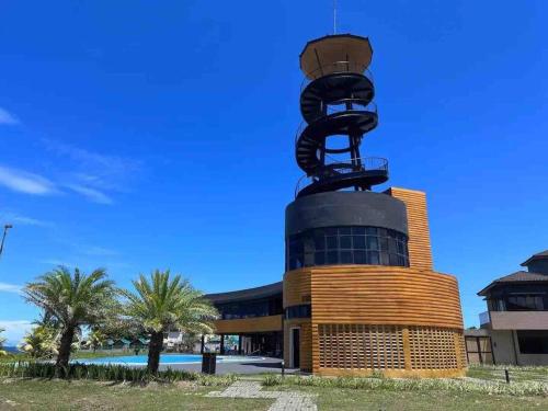 a building with a sculpture on top of it at Beach Hive Seafront Villa at San Juan Batangas in Batangas City